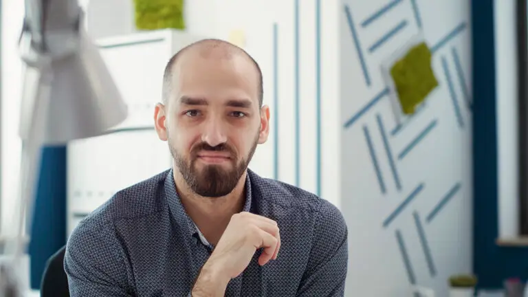 Portrait of office worker sitting at desk to create business report