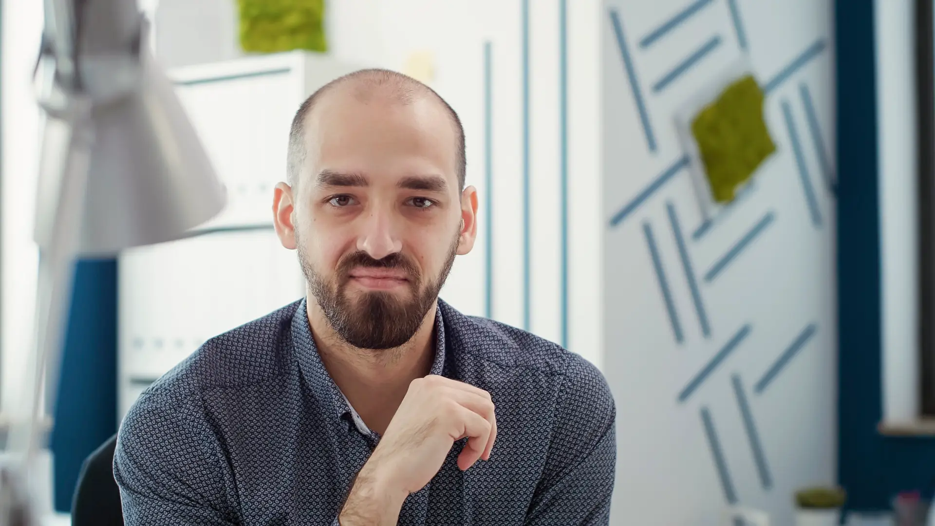 Portrait of office worker sitting at desk to create business report